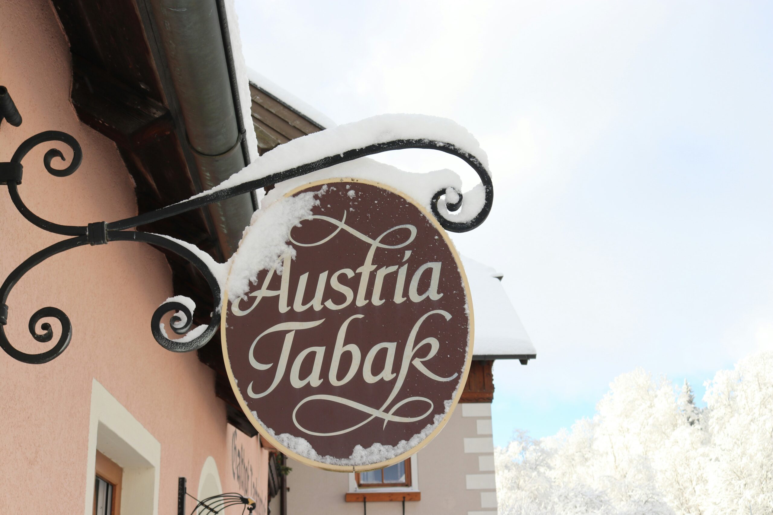 a sign hanging from the side of a building