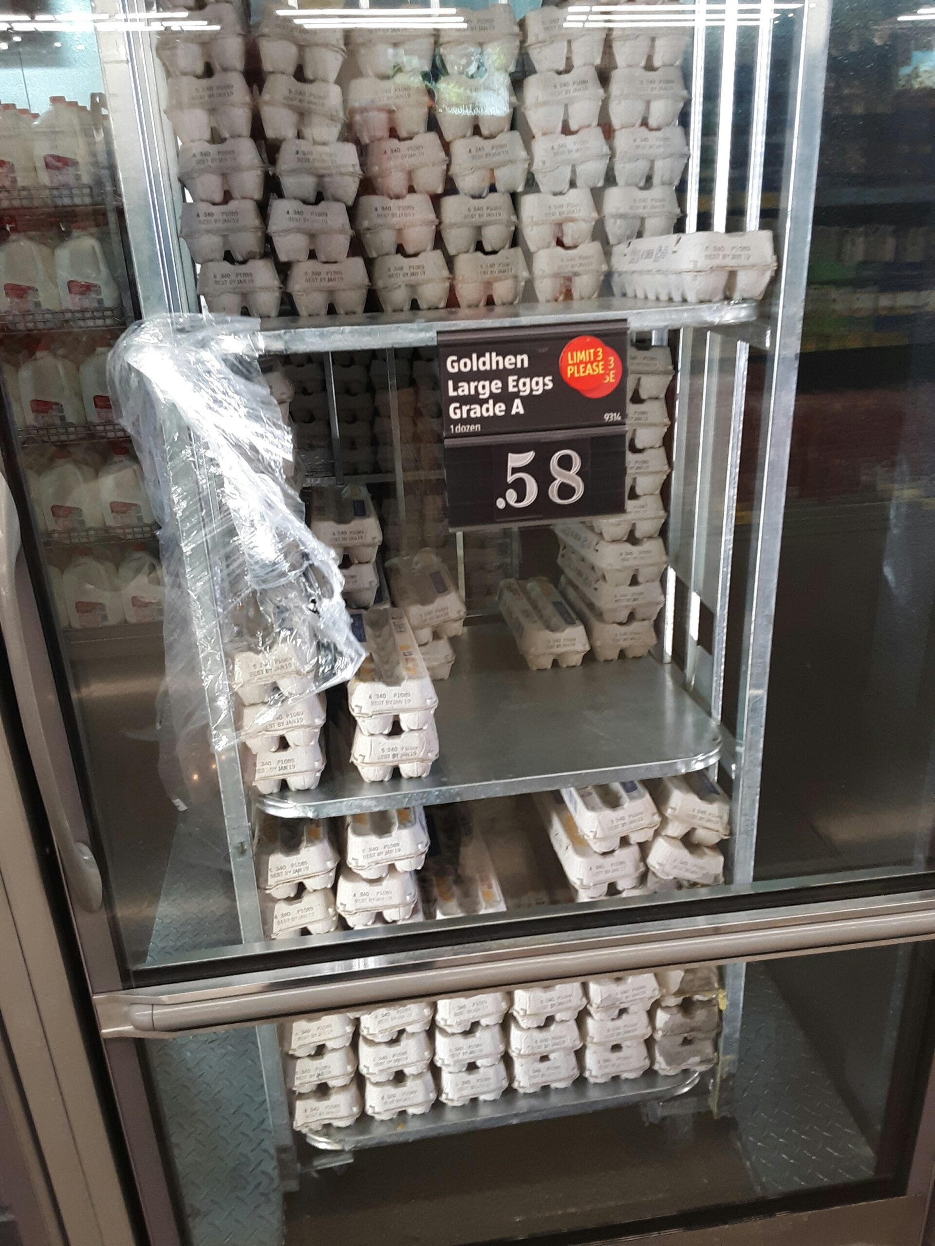A display case filled with lots of white donuts