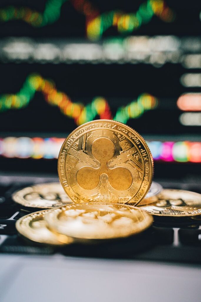 XRP (Ripple) Price Prediction 2025–2030: Will XRP Reach $10? Buy or Sell? Gold Ripple coins on a laptop with a financial chart background, symbolizing digital currency trends.